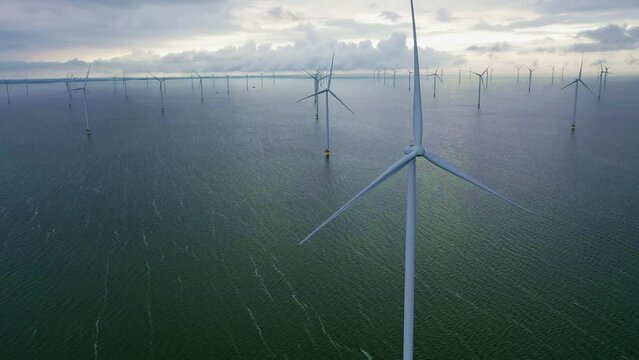 Drone video of enormous windmills stand in the sea along a dutch sea. Frysl&acirc;n wind farm, the largest inland wind farm in the world. Friesland, Afsluitdiijk, Ijsselmeer, Breezanddijk, Netherlands