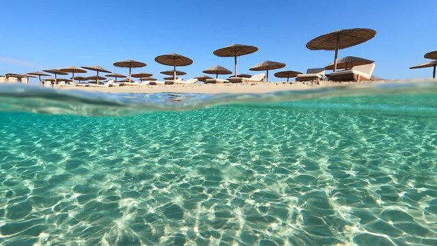 Underwater split video of paradise beach of Simos in island of Elafonisos, Lakonia, Greece