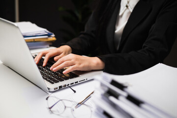 Close up hand woman texting on keyboard laptop work sitting working in office.