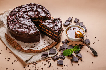 Top view Chocolate cake with salted caramel on a beige background. Homemade delicious pastries. Sweet dessert.