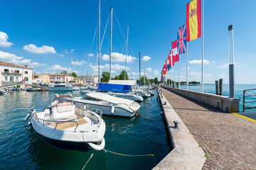 Small port of Bardolino village with small boats moored. Tourist resort on the coast of Lake Garda...