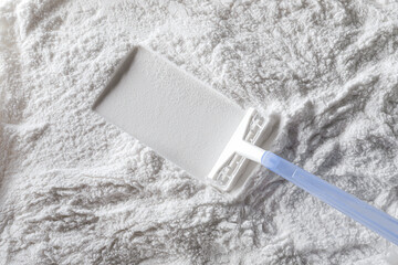 Artistic background, texture of sand and cement with a shaving machine. Color white