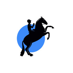 Silhouette of a horse standing on its hind legs with a rider on its back