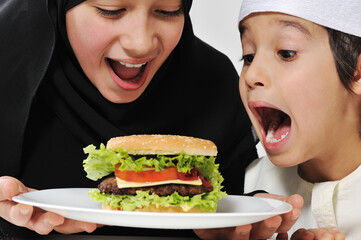 Arabic little male and female eating Burger
