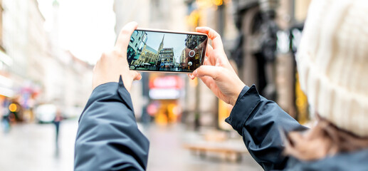 Photographing with smart phone in hand. Travel concept. Wien. Vienna.