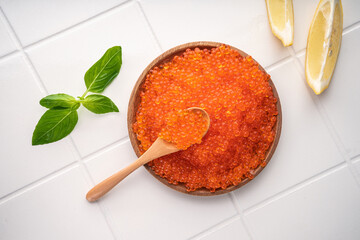 Natural red caviar from trout and salmon. A pure product, a delicacy. On a white background in a...