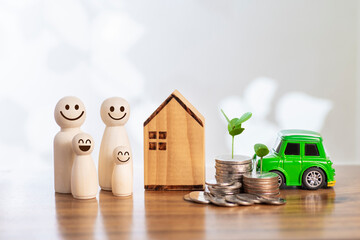 Wooden figures of smiley family members with house car  coin stacks concept investment saving money business finance banking