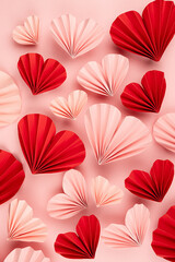 Fun Valentines day festive background in asian style - pink and red paper hearts of folded fans soar on gentle pastel pink color backdrop, top view, copy space, vertical.