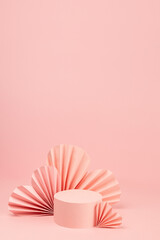 Fashion romance pink scene mockup with single cylinder podium, airy pink origami paper hearts on...
