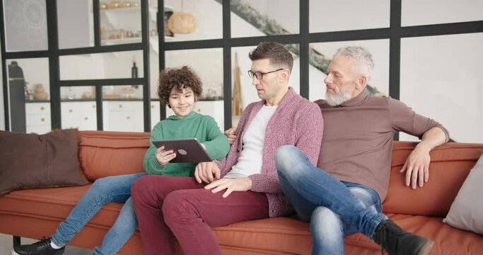 Boy schooler shows funny videos to gay parents on tablet