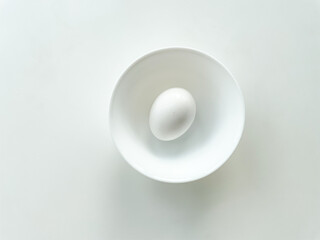 White egg in the white bowl isolated on white background. Protein for eating.