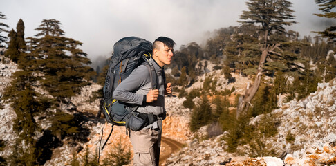 Man is hiking, travelling in the mountains. © Zhanna