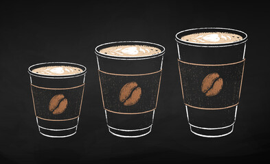 Paper coffee cups in three sizes with milk foam