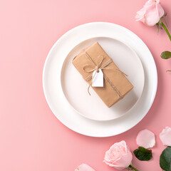 Valentine's Day gift and meal design concept background with pink rose flower on pink background.