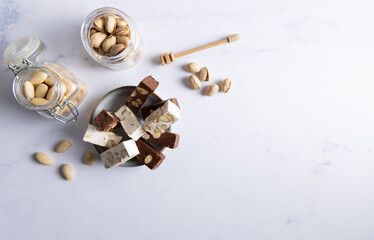 White chocolate covered nougat. Nougat with pistachios and almonds. These delicious confections are filled with the dried almonds and pistachio nuts and covered with white chocolate.