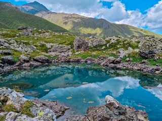 Naklejka na ściany i meble Colorful Abudelauri mountain lakes and hills in the Greater Caucasus Mountain Range in Georgia,Kazbegi Region. Trekking and outdoor travel in mountainous areas.Alpine pastures.Backpacking and trekking