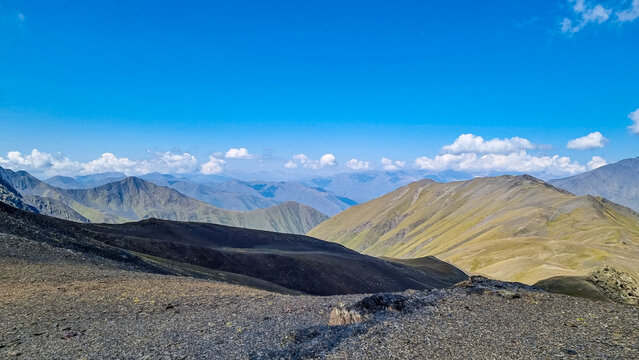 A panoramic view on the sharp mountain peaks of the Chaukhi massif in the Greater Caucasus Mountain Range in Georgia, Kazbegi Region. Mountain Ridges, Hiking. Georgian Dolomites.