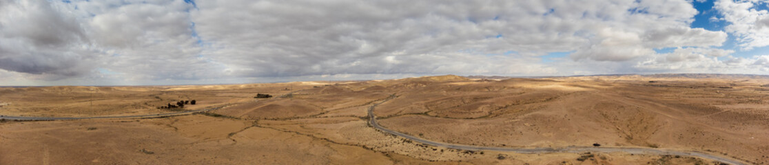 Wide panorama of Negev desert with clouds at wind from a drone in the sky