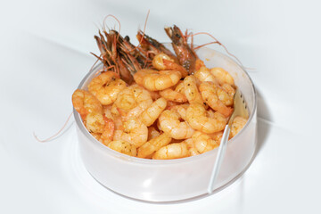 delicious deep fried breaded shrimps served with lime wedges and coriander leaves on white plate on...