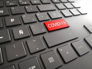 Keyboard  with a big COVID - 19. Picture of red button on the keyboard with word of Coronavirus.
