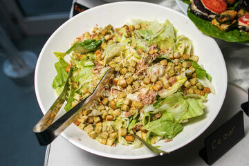 Delicious caesar salad with parmesan cheese, homemade croutons and dressing.