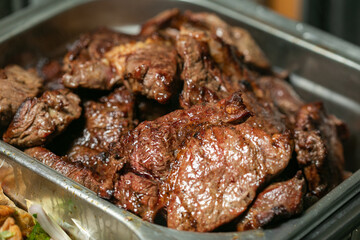 Grilled beef steak in sauce on a tray