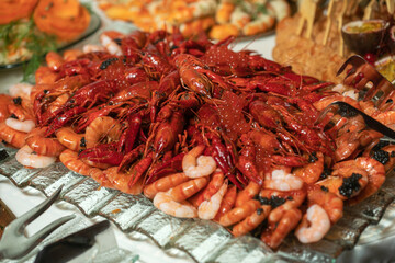 boiled crayfish lie on a platter in a restaurant