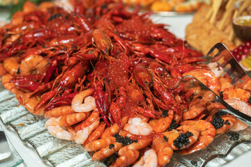 boiled crayfish lie on a platter in a restaurant