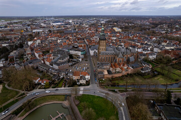 Picturesque aerial view of tower town Zutphen in The Netherlands with medieval Hanseatic city center on the river IJssel and highlighted Walburgiskerk. Panorama of Dutch settlement seen from above.