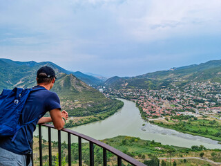 A man enjoying the amazing top view of Mtskheta,Georgia.The old town lies at the confluence of the...