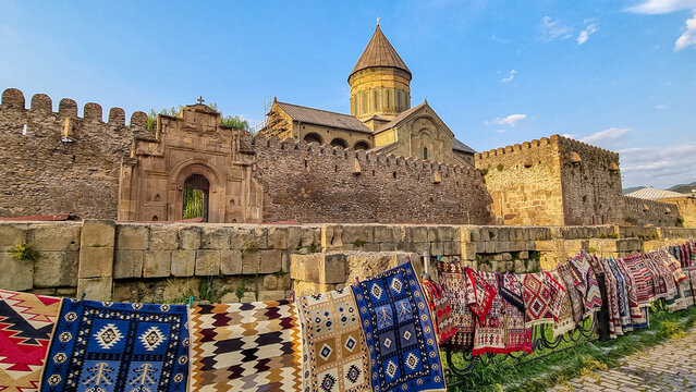 Carpets hanging on the wall of the cathedral of saint kura and the mtskheta river in the town of svetitskhoveli, a historic monument for tourism and religion in the caucasus region. Cathedral.