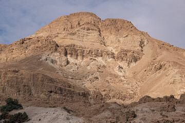 Fototapeta na wymiar Closeup view of Mount Yishai, towering 190 m above Nahal David canyon entrance, Ein Gedi National Park and Nature Reserve, Dead Sea, Judean Desert, Israel 