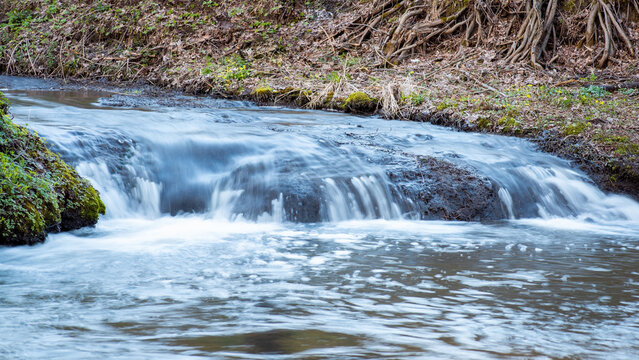 Wide photo of small waterfall shot with long exposure. Little waterfall on the river