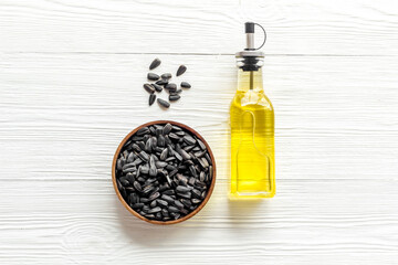 Sunflower oil in bottle with seeds. Cooking oil background