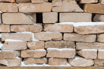 Heap of gray bricks close up. the pile of brick stones. the brown bricks stacked. textured background for creative design elements.