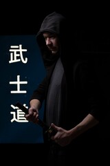 Handsome portrait of a man with katana Japanese sword.