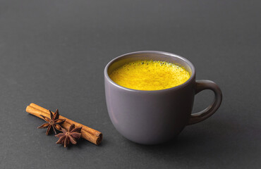 Gray cup with golden milk (turmeric milk).