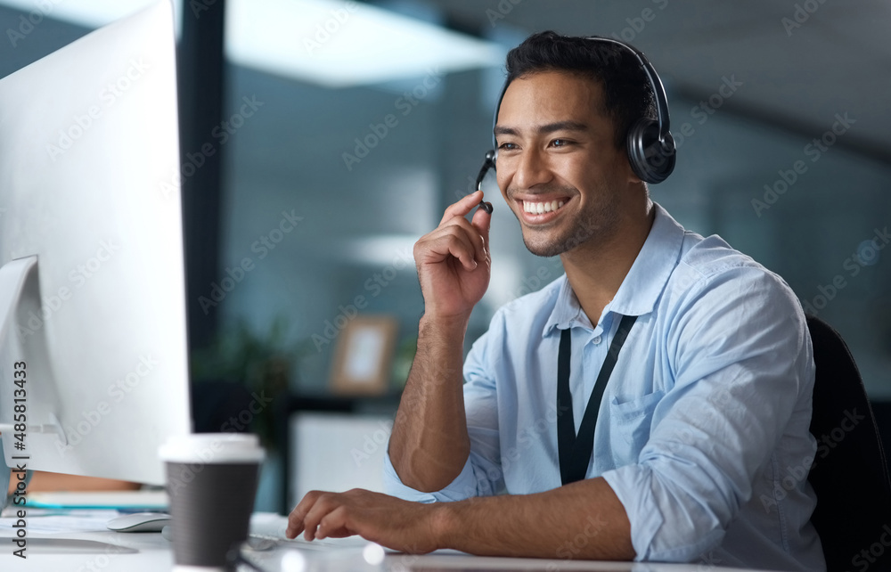 Poster have you heard about our latest package. shot of a young man using a headset and computer in a moder
