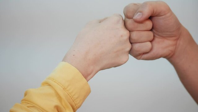 social distance. teamwork. fist to fist commit a respect and brotherhood gesture. business team hands fists. people of different skin colors partnership friendship solidarity teamwork social distance