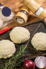 Roasted cutlets from beef and pork meat. Black background. Top view