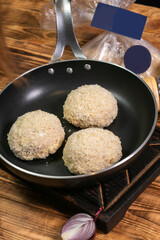 Roasted cutlets from beef and pork meat. Black background. Top view