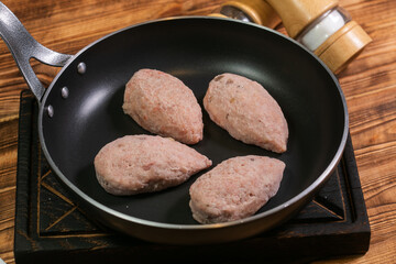 Roasted cutlets from beef and pork meat. Black background. Top view