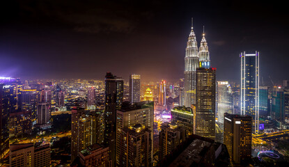 Panorama aerial night view of Kuala Lumpur city skyline. Malaysia. Purple mode