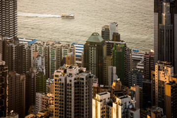 Naklejka premium Boats in Victoria Harbour at sunset, seen from Victoria Peak, Hong Kong Island, Hong Kong, China