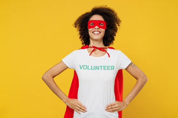 Young woman of African American ethnicity wears white volunteer t-shirt super hero costume stand...