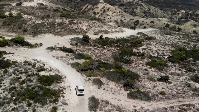 Aerial view of a car driving on a dirt road on Kos island