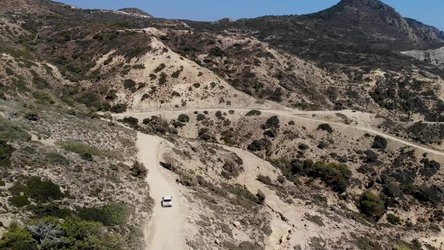 Aerial view of a car driving on a dirt road on Kos island