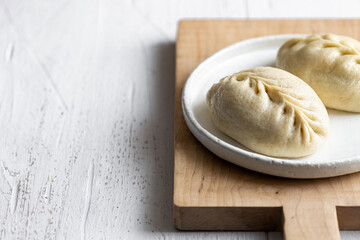 Traditional Korean steamed pie, pyanse or pigodi, on white wooden background, selective focus