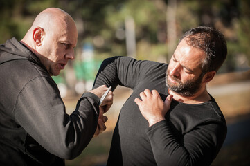 Knife threat. Self defense disarming technique against knife attack