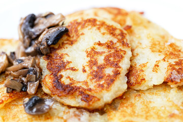 Fresh fried potato fritters with mushroom